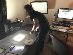 Chris Antkowiak prepares to photograph decaying nitrate negatives using a light box. Due to the risk of combustion, the negatives were stored in a refrigerator and individually removed by the photographer just prior to imaging. Chris Antkowiak (CUL Preservation & Digital Conversion Division) prepares to photograph decaying nitrate negatives using a light box. Due to the risk of combustion, the negatives were stored in a refrigerator and individually removed by the photographer just prior to imaging.