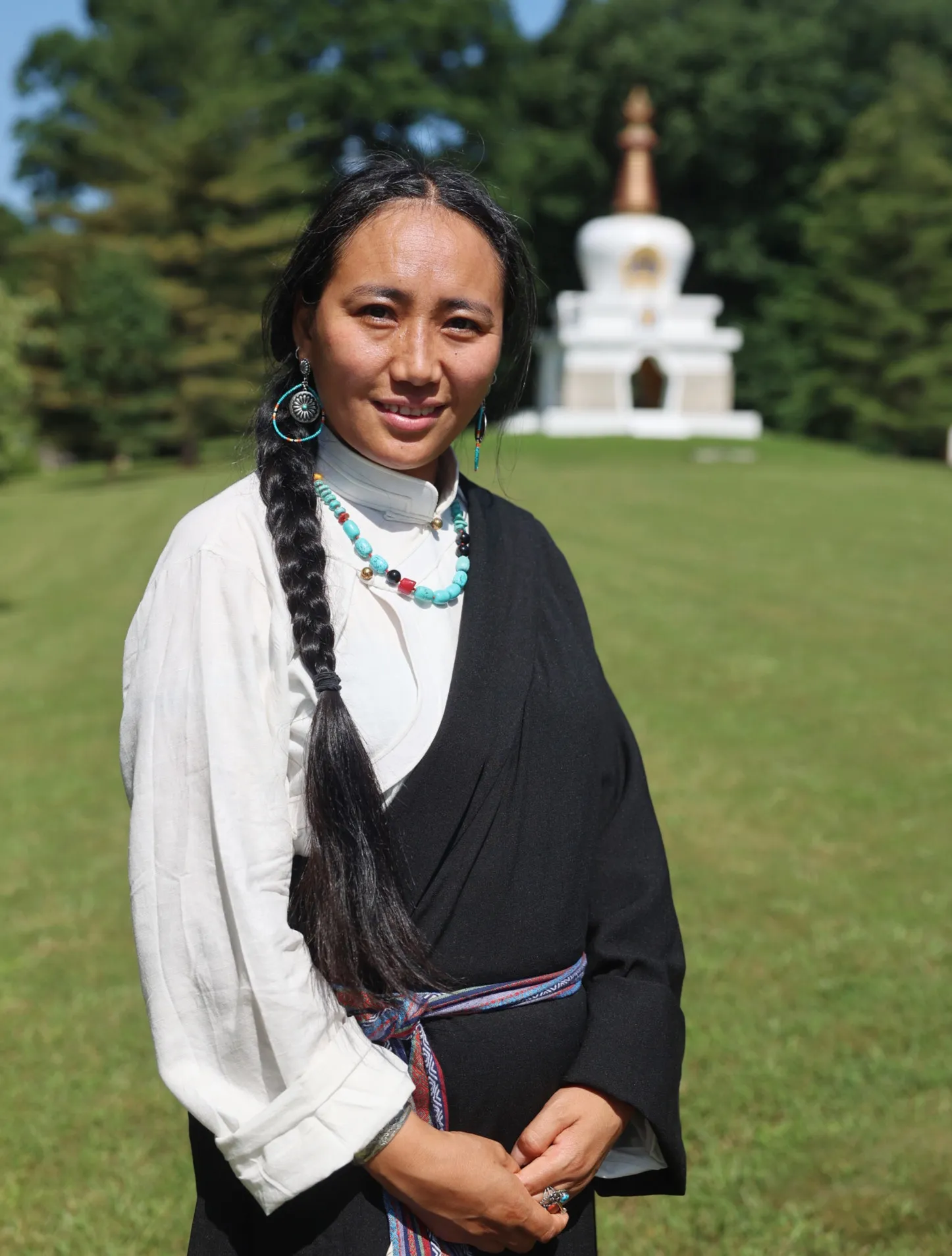 Photo of Tashi Dekyid Monet near Tibetan Buddhist stupa.
