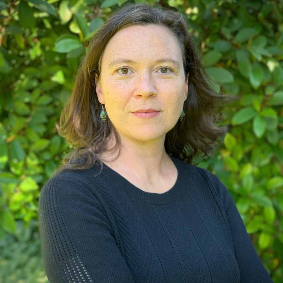 Woman in front of greenery